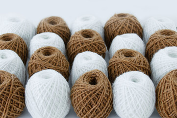 Brown and white skeins of wool. Selective focus.