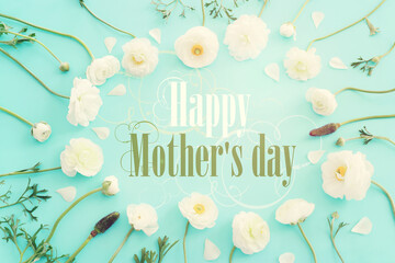 mother's day concept with white flowers over blue pastel background