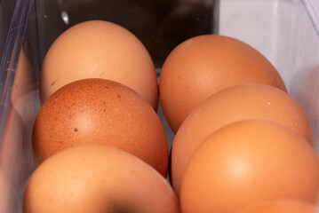 Eggs in the refrigerator arranged in rows. Low temperature storage of eggs. The structure of the...
