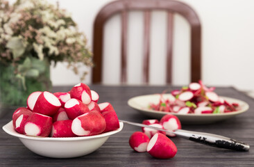 cooked crispy radish in white bowl on wooden table