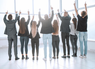 rear view. a group of business people together pointing up at a copy of the space