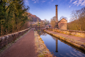 View of mackerel sky and old pump station beside the Cromford Canal, Derbyshire