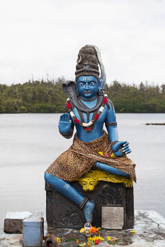 Statue of Vishnu, the Hindu god with cobra and wearing a leopardskin, in human form as Krishna, at Ganga Talao, Mauritius, Indian Ocean