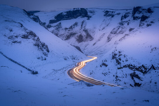View of trail lights on snow covered Winnats Pass near Castleton, Derbyshire
