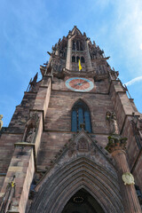 Fototapeta na wymiar The Tower of the Freiburg Minster with clock in the city of Freiburg