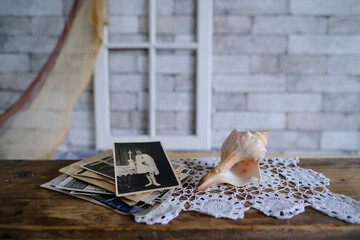 stack of vintage photos, old photography of 1940-1950 on wooden table, concept of genealogy, the...