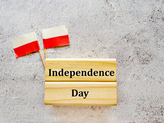 Independence Day Greeting Card with Poland Paper Flags on Gray  Textured Background 