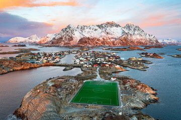 Aerial view of soccer stadium and Henningsvaer village during winter dawn, Nordland county, Lofoten Islands
