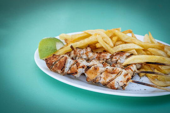 Souvlaki, popular Greek food consisting of small pieces of meat grilled on a skewer served with french fries, Greek Islands