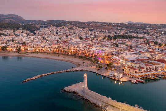 Aerial view of Venetian harbour and lighthouse at sunset, Rethymno, Crete island, Greek Islands