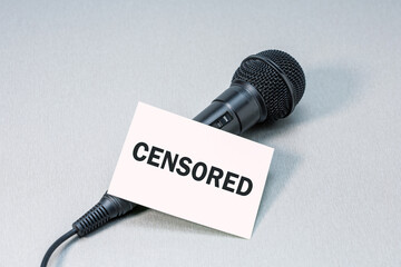 Microphone with blank SENSORED on a desk. World press freedom day, free speech concept.