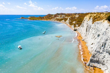 Aerial view of majestic limestone cliffs framing the golden sand of Xi beach, Kefalonia, Ionian Islands, Greek Islands