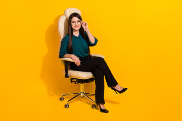 Full body profile side photo of young lovely woman eyewear clever sit stool isolated over yellow color background