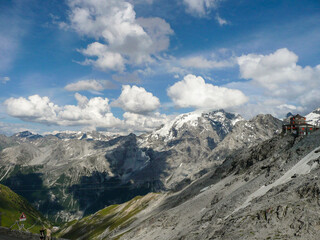 Panoramic view of the beautiful landscape in the Alps with fresh green meadows and blooming flowers...