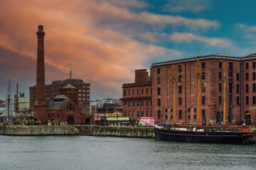 Evening view of Royal Albert Dock brick and stone buildings and warehouses, including The Pumphouse, Liverpool, Merseyside