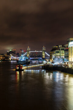 Tower Bridge and HMS Belfast on River Thames at night, London