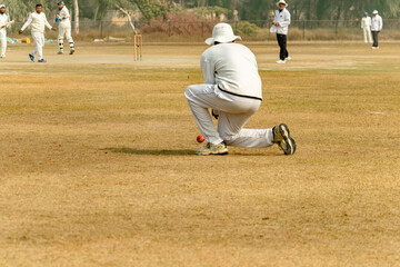 fielder catching ball in match ground