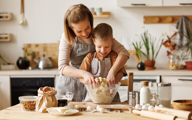 Happy mother and son preparing dough together - obrazy, fototapety, plakaty
