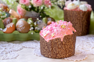 Easter cake with pink icing, pink dragees and golden decor