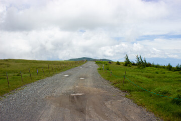 Winding roads on the plateau with clouds in the background