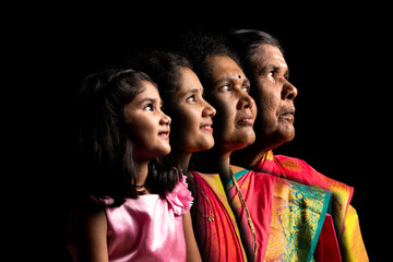four generation Indian family in traditional dress - concept of aging process, family and...