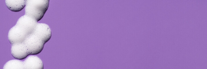 Foam swatch on a purple background. Soapy liquid texture with bubbles.