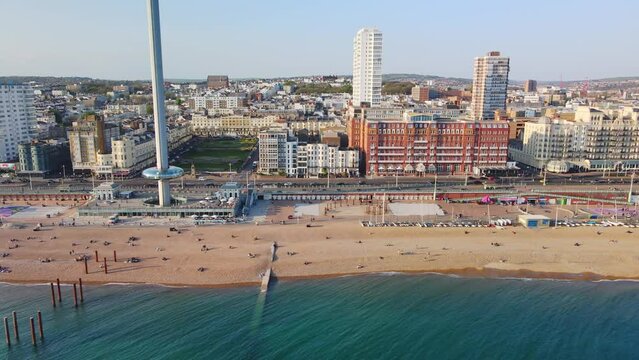 Drone shot of Brighton Palace Pier, with the seafront behind. Aerial shot of the stunning city of Brighton and Hove with seagulls flying around