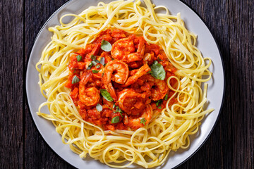 shrimps in tomato sauce with pasta, top view