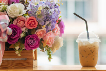 An iced cappuccino caffeinated beverage is placed on counter at  customer's order because caffeinated beverage is refreshing and able to work like boss effective.Copy Space for advertisements