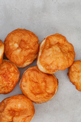 South African vetkoek, deep fried savory dough, on mottled grey background with copy space