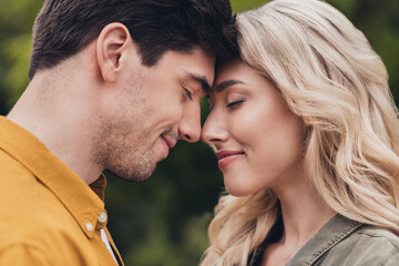 Fototapeta premium Cropped profile side view portrait of attractive dreamy careful amorous couple bonding enjoying resting time fresh air outdoors