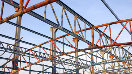 Low angle view of metal roof structure for install on top of building structure in construction site area