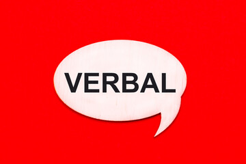 On a bright red background, a light wooden curly card with the text VERBAL