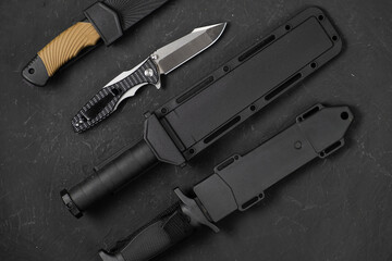 folding knives on a black background. pen knives on a dark background