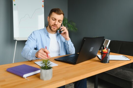 Computer Programmer Writing Program Code On Computer In Office