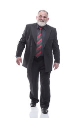 confident elderly businessman striding forward. isolated on a white