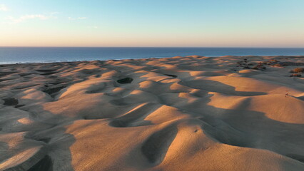Sand dunes meet the Atlantic Ocean. Top view of Maspalomas sand dunes.