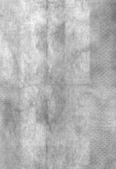 detail scan of thin white handkerchief, folded paper surface.