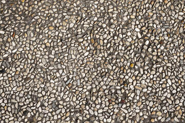 Pebbles in pavement background texture
