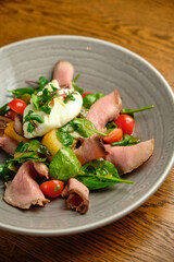 Grilled spicy lamb and salad wrapped in flatbread, with tomatoes