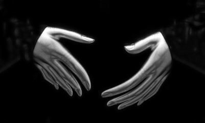 monochromatic pair of mannequin model hands preparing to shake hands in greeting