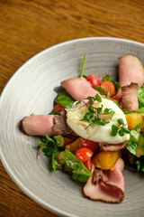 Grilled spicy lamb and salad wrapped in flatbread, with tomatoes