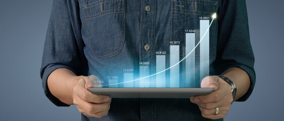 Businessman plan graph growth increase of chart positive indicators on tablet in hand