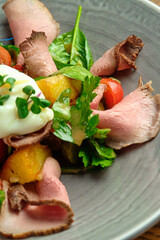 Grilled spicy lamb and salad wrapped in flatbread, with tomatoes