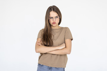Fototapeta premium Portrait of a happy woman standing with arms folded on a white background