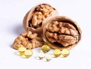 Ripe walnuts and capsules with a vitamin