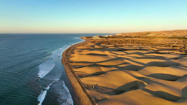 Sand dunes meet the Atlantic Ocean. Top view of Maspalomas