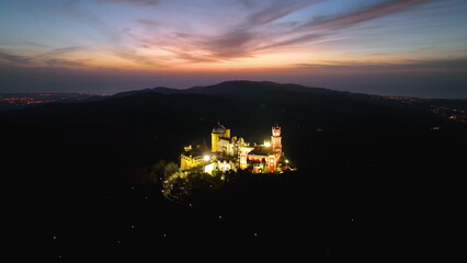 Aerial view of stunning Pena Castle at night. Top view of illuminated Sintra - obrazy, fototapety, plakaty