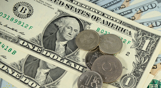 Russian ruble coins lie on 1 american dollar and 100 dollars