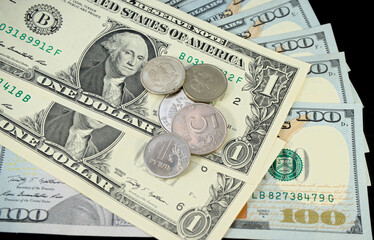 Russian ruble coins lie on 1 american dollar and 100 dollars